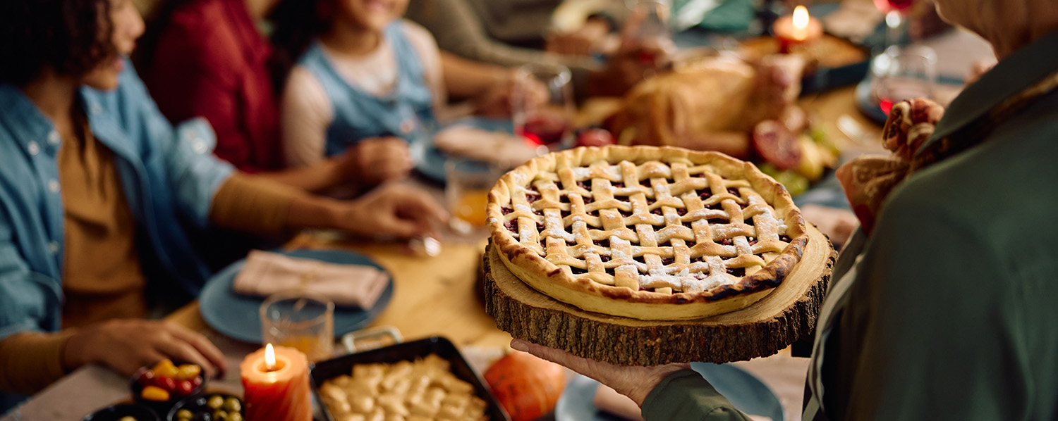 beautiful and hearty thanksgiving meal splayed across a table filled with family