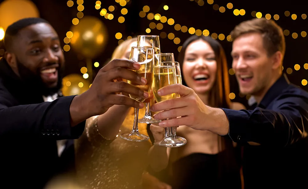 a group of dressed up people clinking champagne glasses